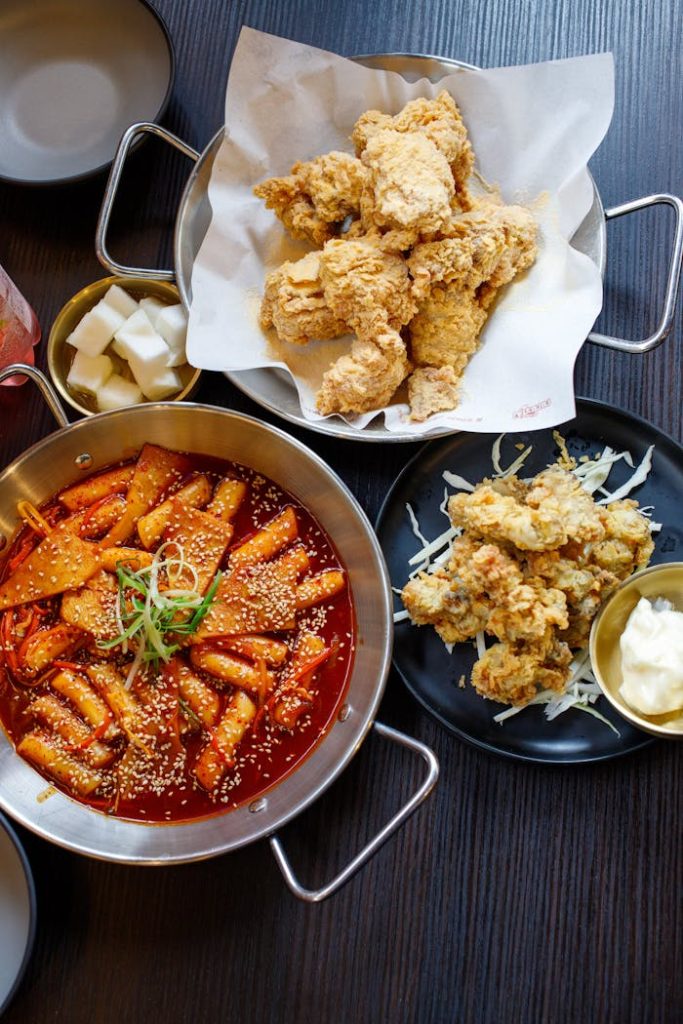 pexels photo 30246917 Mouthwatering Korean fried chicken paired with spicy tteokbokki for a perfect Asian fusion meal.